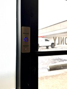 press to exit button on an access control system installation at a local fitness facility